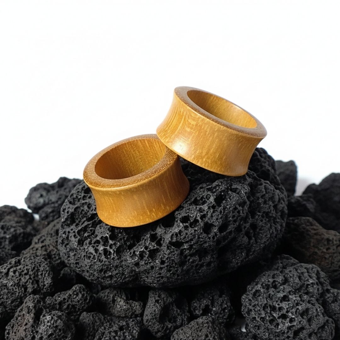 Pair of organic Jackfruit wood tunnels shown up close. Lightweight, natural gauges for stretched ear piercing culture.