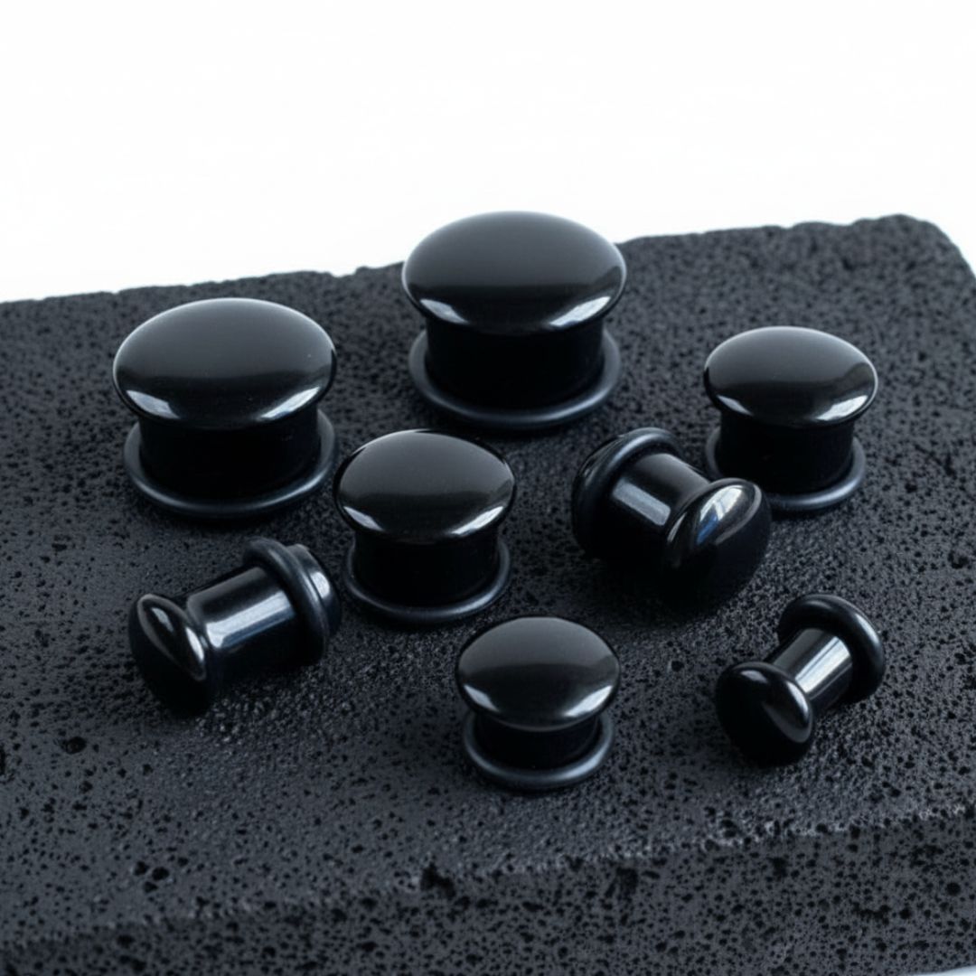 Single Flare Onyx Stone Plugs shown on volcanic stone against a clean white background.