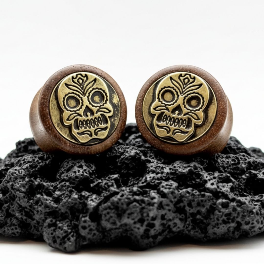 Pair of organic wood plugs carved with intricate Sugar Skull / Dia de Muertos design. Dark brown wood gauges 8mm-16mm.