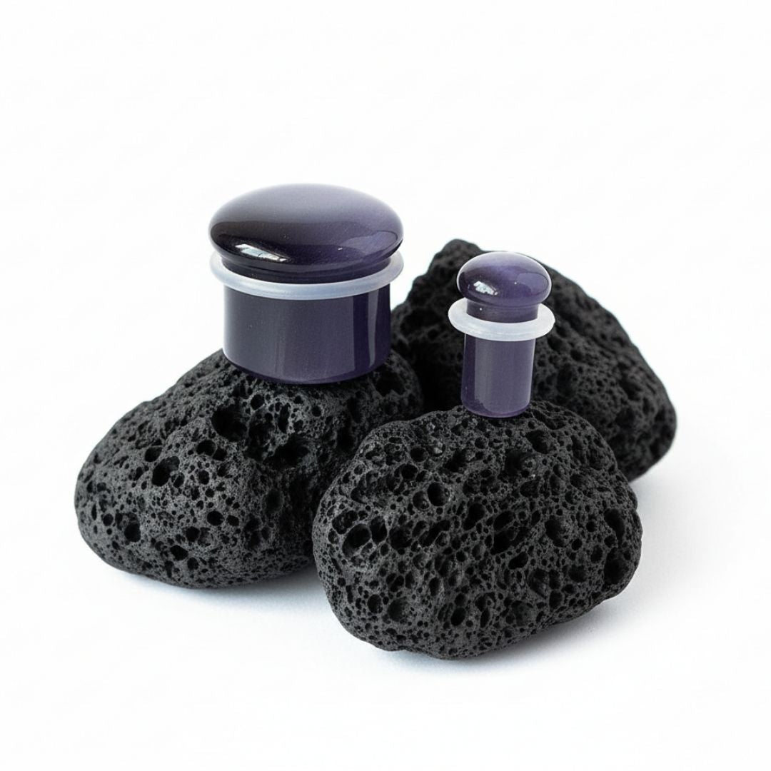 Pair of deep purple violet cat eye stone plugs with a reflective line, double flared gauges, sizes 2G to 16mm.