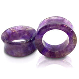 A pair of amethyst stone tunnels for stretched ears