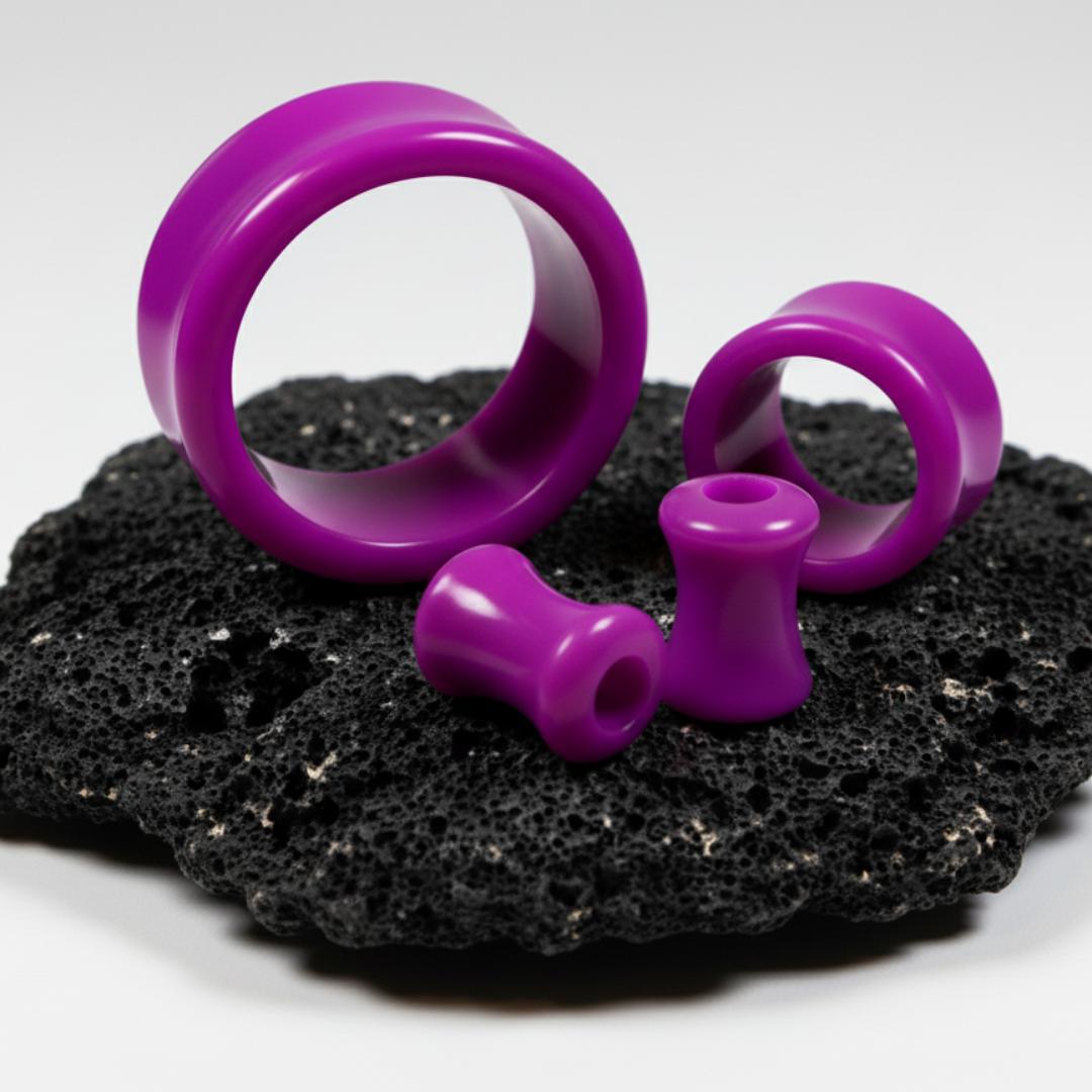 Purple Acrylic Tunnels for stretched ears on black stone