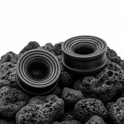 Pair of dark brown Areng wood ripple tunnels shown on a neutral background. Organic wood gauges for stretched ear piercing culture.