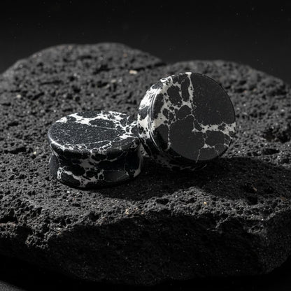 Close up photo of Black Imperial Turquoise stone plugs/gauges showing deep natural black matrix veins. Stretched ear jewelry.