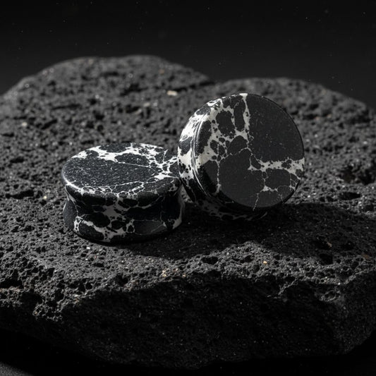 Close up photo of Black Imperial Turquoise stone plugs/gauges showing deep natural black matrix veins. Stretched ear jewelry.