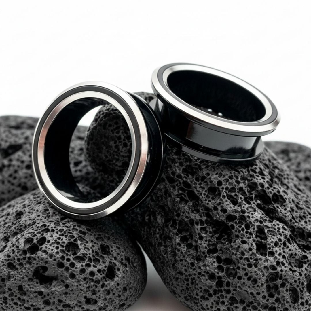 Black and silver PVD coated surgical steel tunnels (gauges) for stretched ears. Alt jewelry aesthetic.