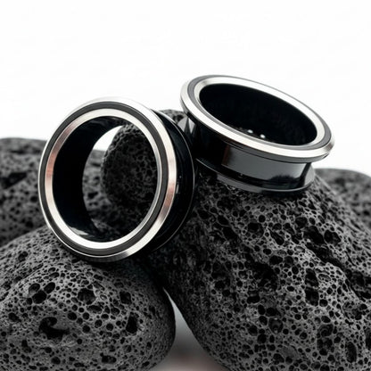 Black and silver PVD coated surgical steel tunnels (gauges) for stretched ears. Alt jewelry aesthetic.