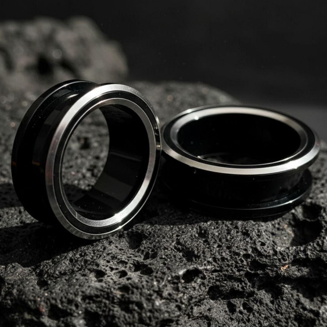 Black and silver PVD coated surgical steel tunnels (gauges) for stretched ears. Alt jewelry aesthetic.