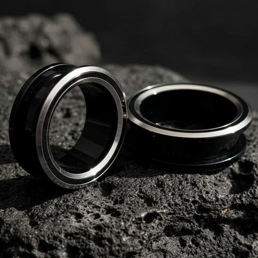 Black and silver PVD coated surgical steel tunnels (gauges) for stretched ears. Alt jewelry aesthetic.