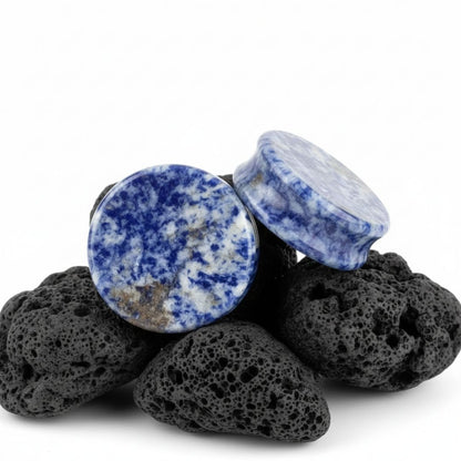 Blue Denim Lapis stone plugs in varying sizes (3mm to 38mm) on a black background. Best gauges for stretched lobes.