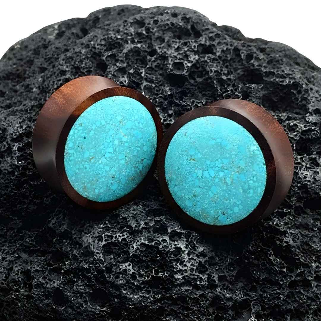 crushed turquoise plugs made from sono wood on volcanic stone for stretched ears