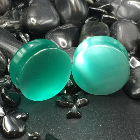 Dragon's Eye Stone Plugs showcasing vibrant aqua blue hue