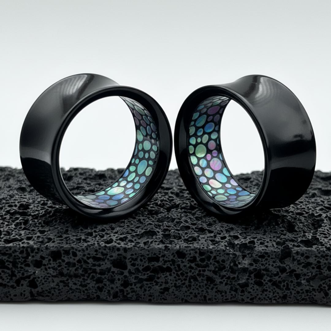 black acrylic tunnels for stretched ears with a faux abelone inlay