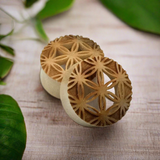 wood plugs for stretched ears featuring flower of life pattern