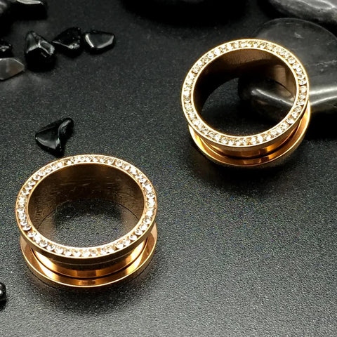 Lustrous rose gold steel tunnels, accentuated with inner gems. Where charm meets glitz.