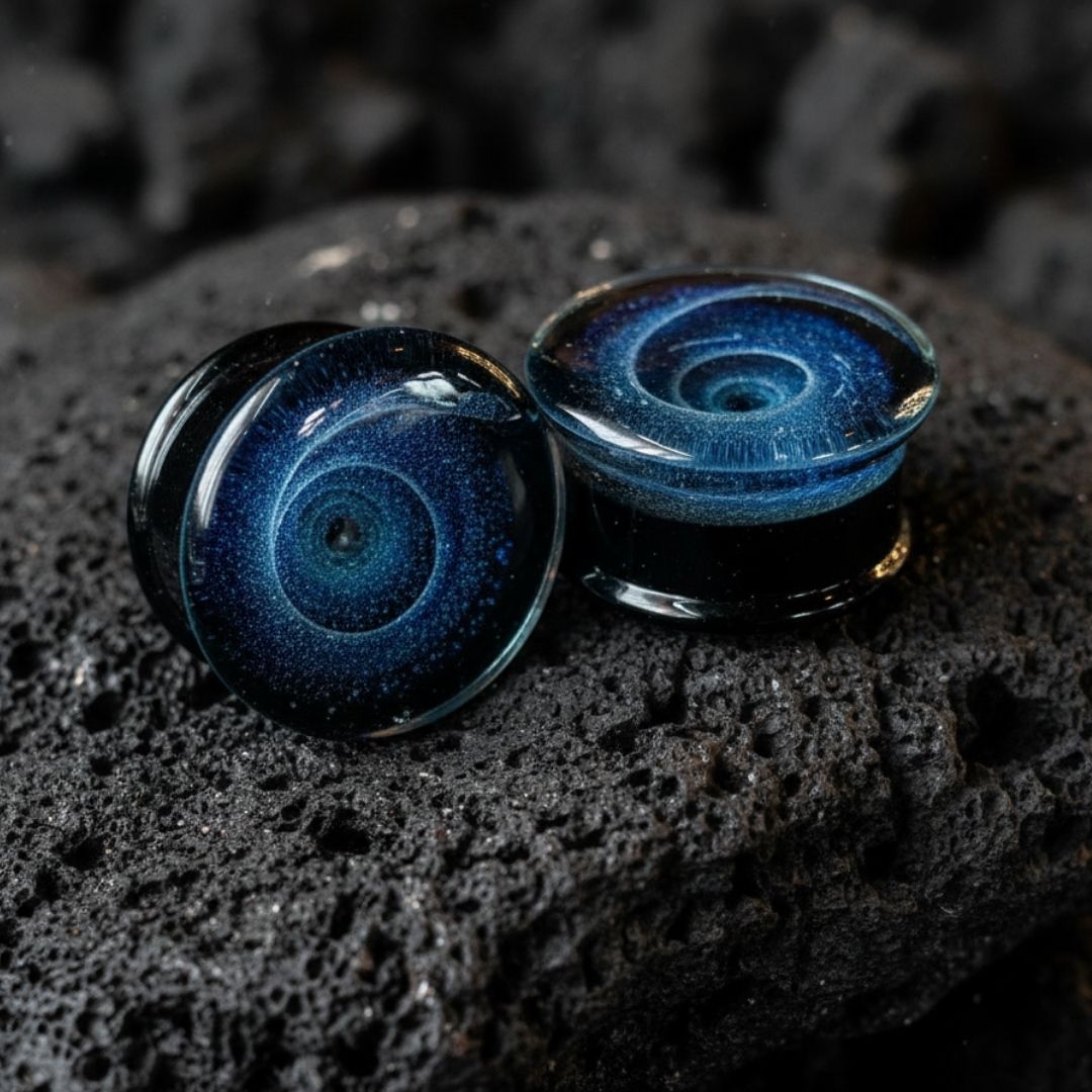 Pair of deep blue Galaxy Glass Plugs for stretched ears, ranging from 6mm (2G) to 25mm (1 inch). Alt style gauges.