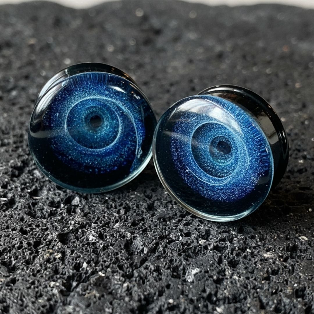 Pair of deep blue Galaxy Glass Plugs for stretched ears, ranging from 6mm (2G) to 25mm (1 inch). Alt style gauges.