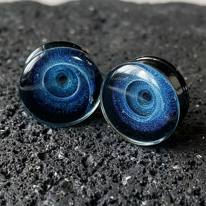 Pair of deep blue Galaxy Glass Plugs for stretched ears, ranging from 6mm (2G) to 25mm (1 inch). Alt style gauges.