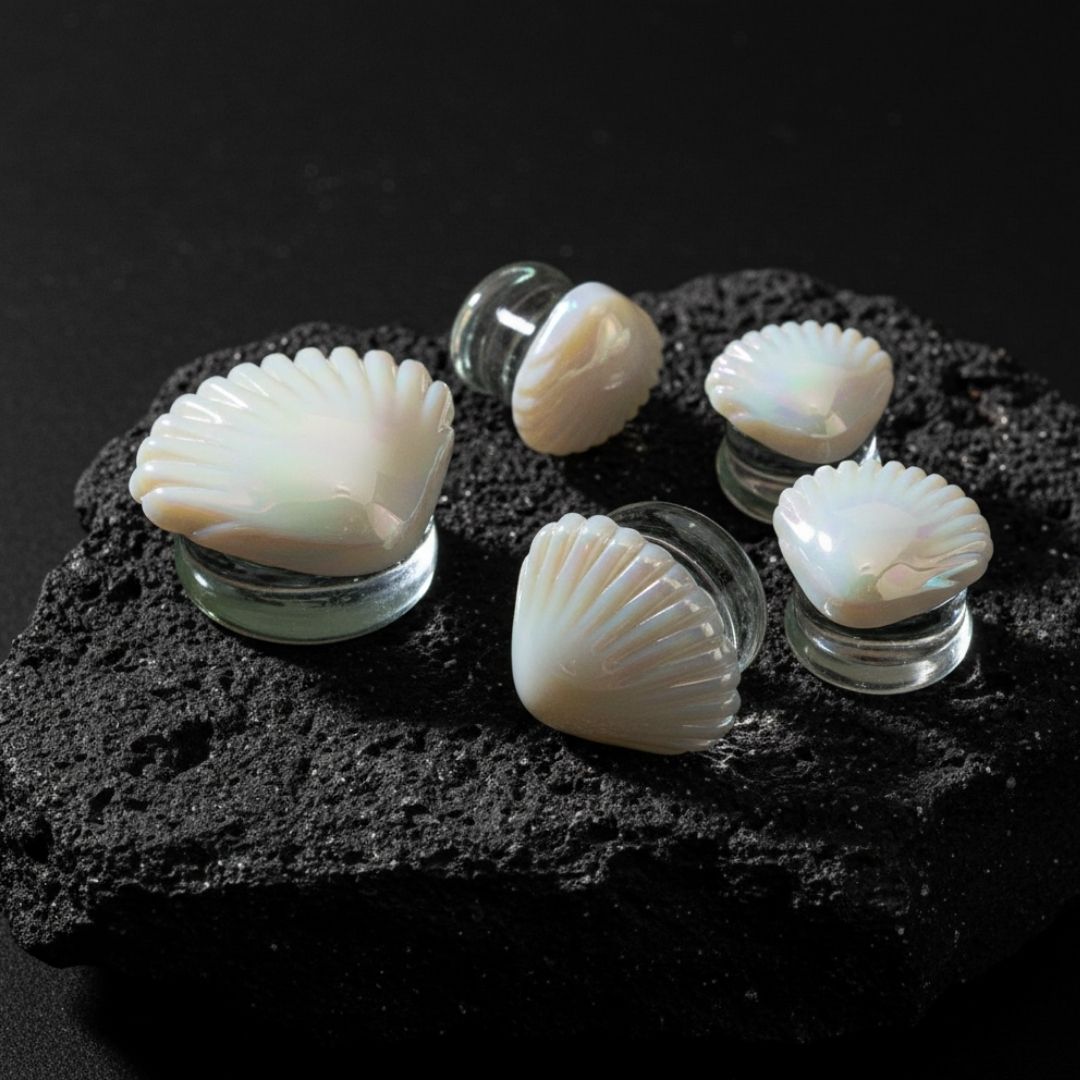 Pair of pearlescent iridescent glass plugs resembling seashells. Best unique gauges for stretched ears 6mm to 25mm.