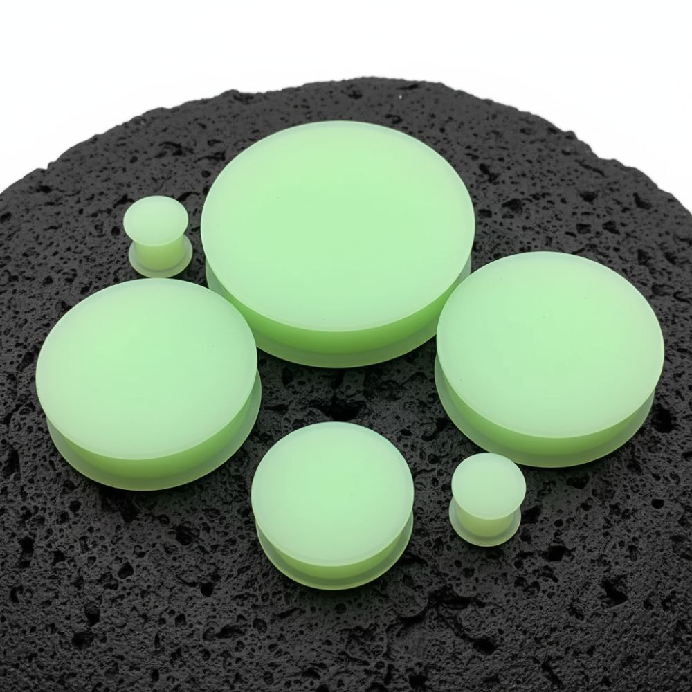 A pair of Glow in the Dark Silicone Plugs (6mm-51mm) on a white studio background.
