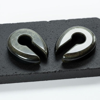Golden Obsidian Stone Hangers (6-10mm) on a dark stone against a white studio background.