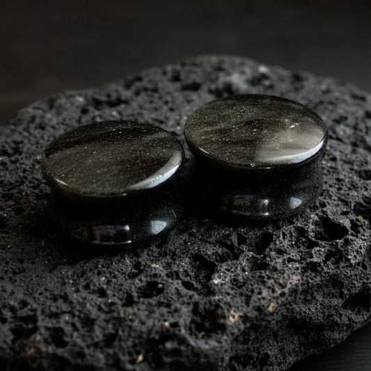 Pair of Golden Obsidian stone plugs (6mm to 25mm) showing the natural gold flash on the black stretched ear gauges.