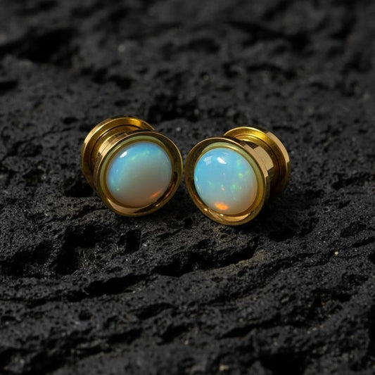 Golden stainless steel plugs with a milky white and iridescent Opalite stone inlay. Gauges for stretched ear lobes.