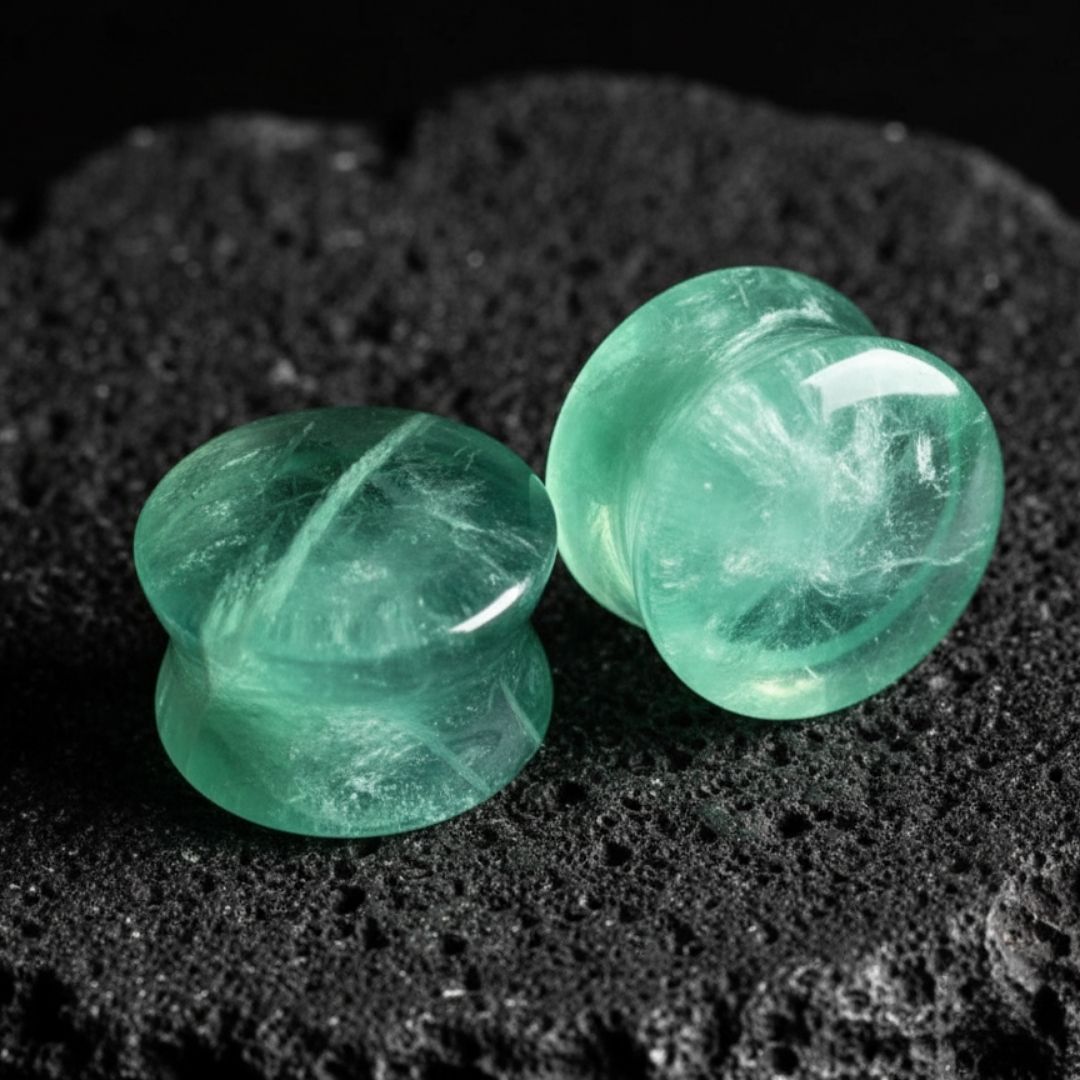 A pair of double flare Green Fluorite stone plugs, showing natural banding. Gauges for stretched lobes, sizes 6G to 1 inch.