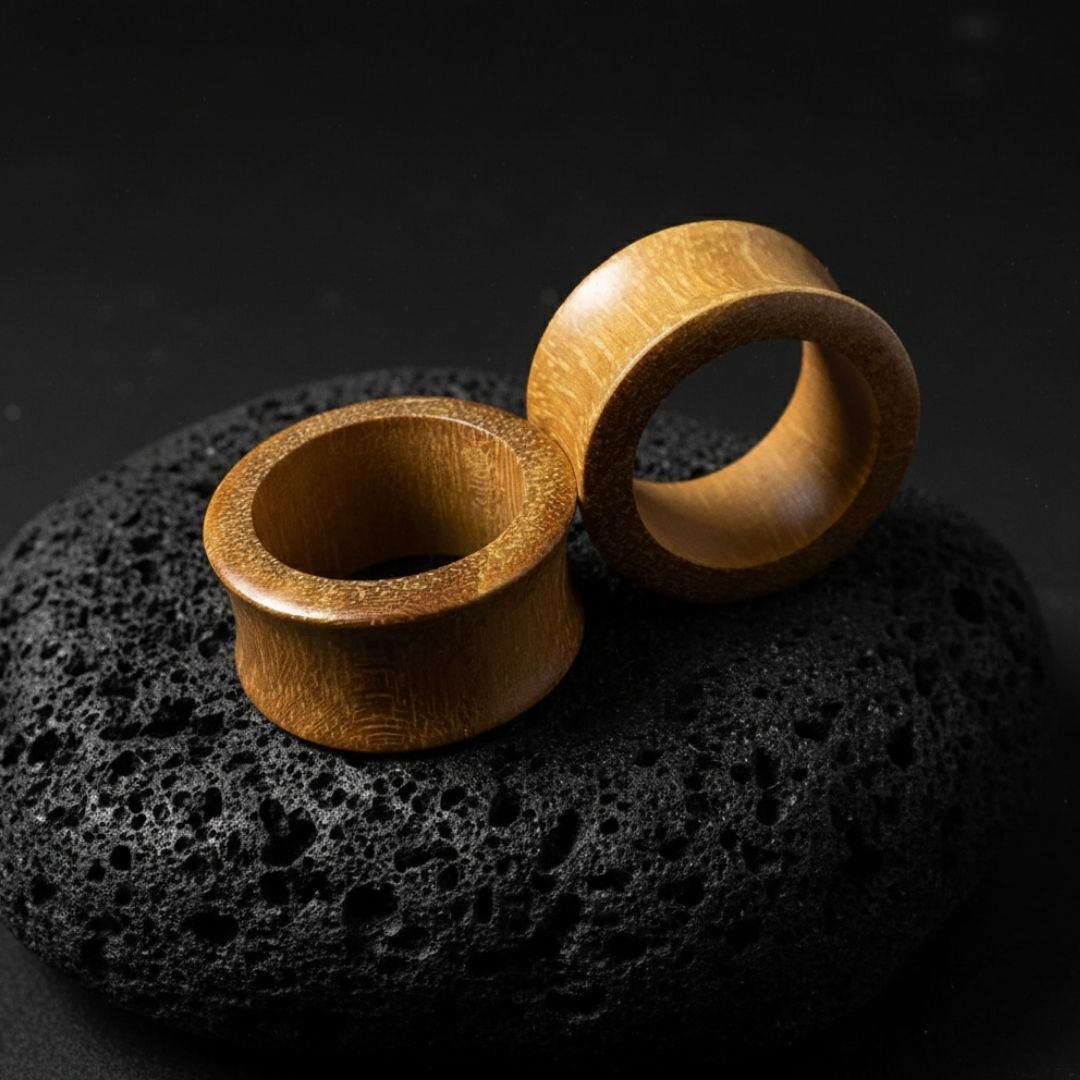Pair of organic Jackfruit wood tunnels shown up close. Lightweight, natural gauges for stretched ear piercing culture.