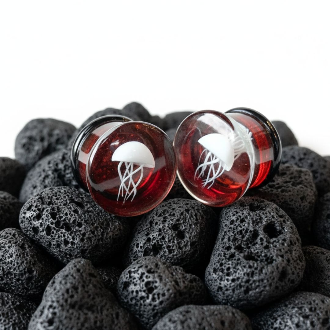 Pair of double flare Red Jellyfish Glass Plugs. Artistic, high-quality gauges made for comfortable stretched ear jewelry (0G to 3/4").