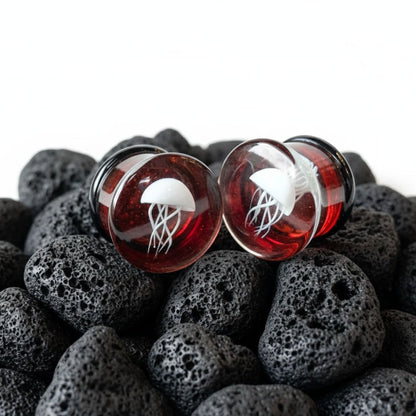 Pair of double flare Red Jellyfish Glass Plugs. Artistic, high-quality gauges made for comfortable stretched ear jewelry (0G to 3/4").
