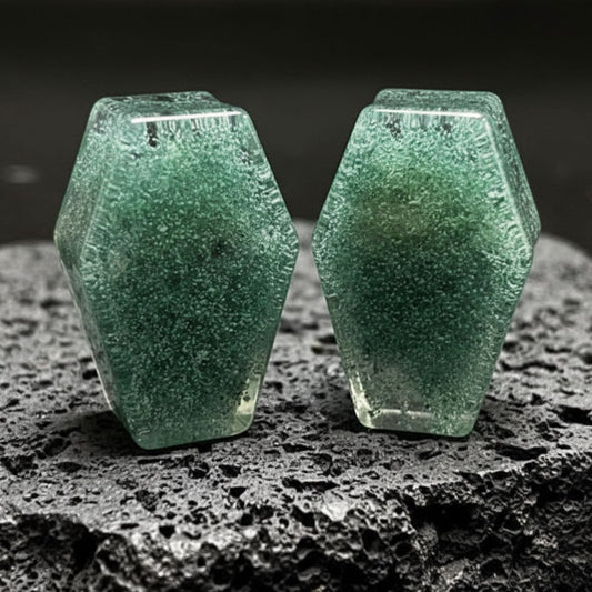 A pair of round Moss Glass Plugs, crafted from smooth green and brown stone glass, displayed against a neutral background.