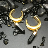Gold saddle spreaders adorned with a dangling onyx gem.