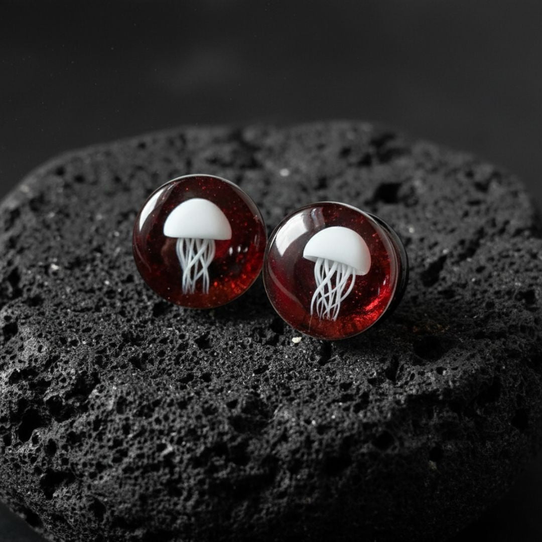 Pair of double flare Red Jellyfish Glass Plugs. Artistic, high-quality gauges made for comfortable stretched ear jewelry (0G to 3/4").