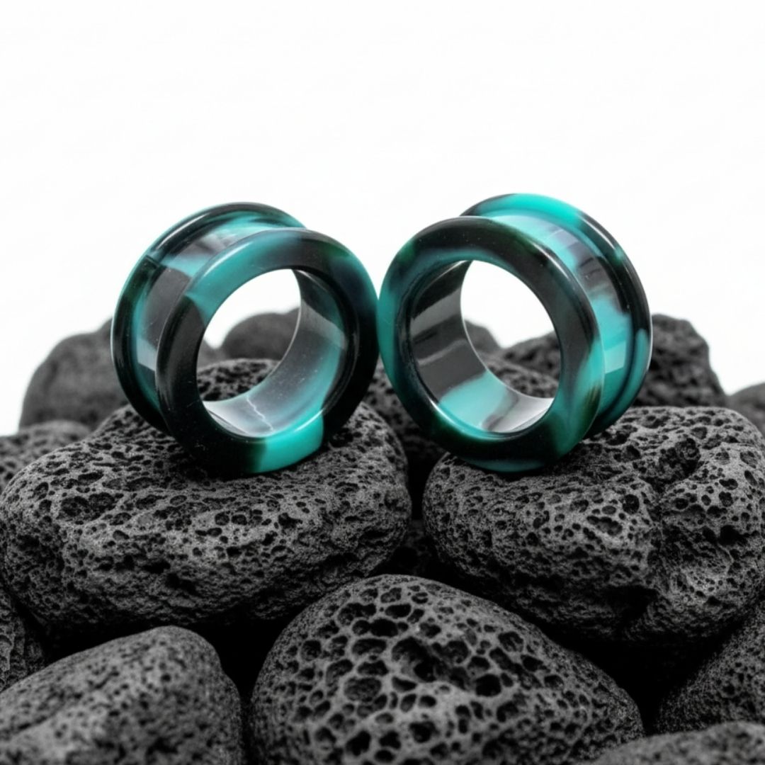 Pair of black retro silicone tunnels for stretched ears, gauges 2G to 2 inches, shown against a dark, alternative background.