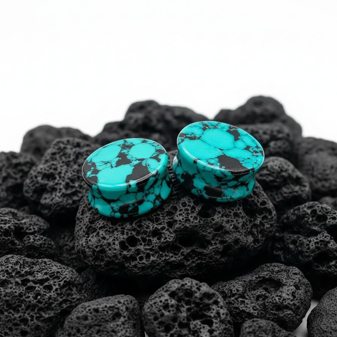 Retro Teal Turquoise stone plugs (6mm to 25mm) displayed on a dark surface, highlighting natural matrix veining.