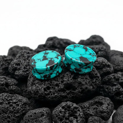 Retro Teal Turquoise stone plugs (6mm to 25mm) displayed on a dark surface, highlighting natural matrix veining.