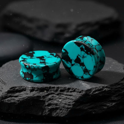 Retro Teal Turquoise stone plugs (6mm to 25mm) displayed on a dark surface, highlighting natural matrix veining.