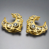 a pair of gold saddle spreaders for stretched ears