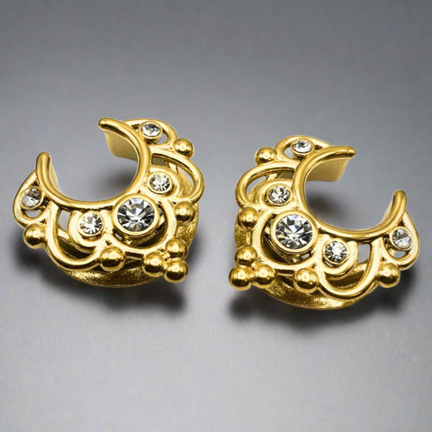 a pair of gold saddle spreaders for stretched ears