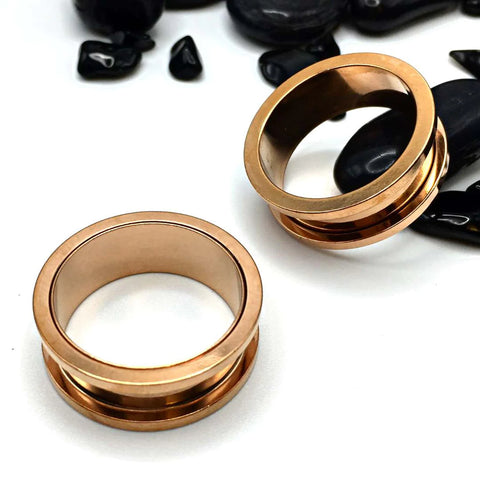 Elegant rose gold-hued steel tunnels with a precise screw-fit design.