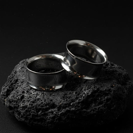 Pair of double flare surgical steel tunnels, showing the hollow center. Best gauges for stretched ear piercing culture.