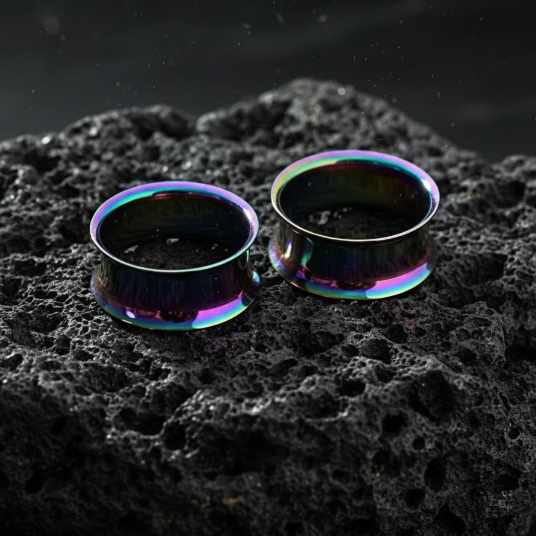 Pair of double flare steel tunnels with an iridescent rainbow finish for stretched lobes. Sizes 3mm to 25mm.