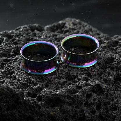 Pair of double flare steel tunnels with an iridescent rainbow finish for stretched lobes. Sizes 3mm to 25mm.