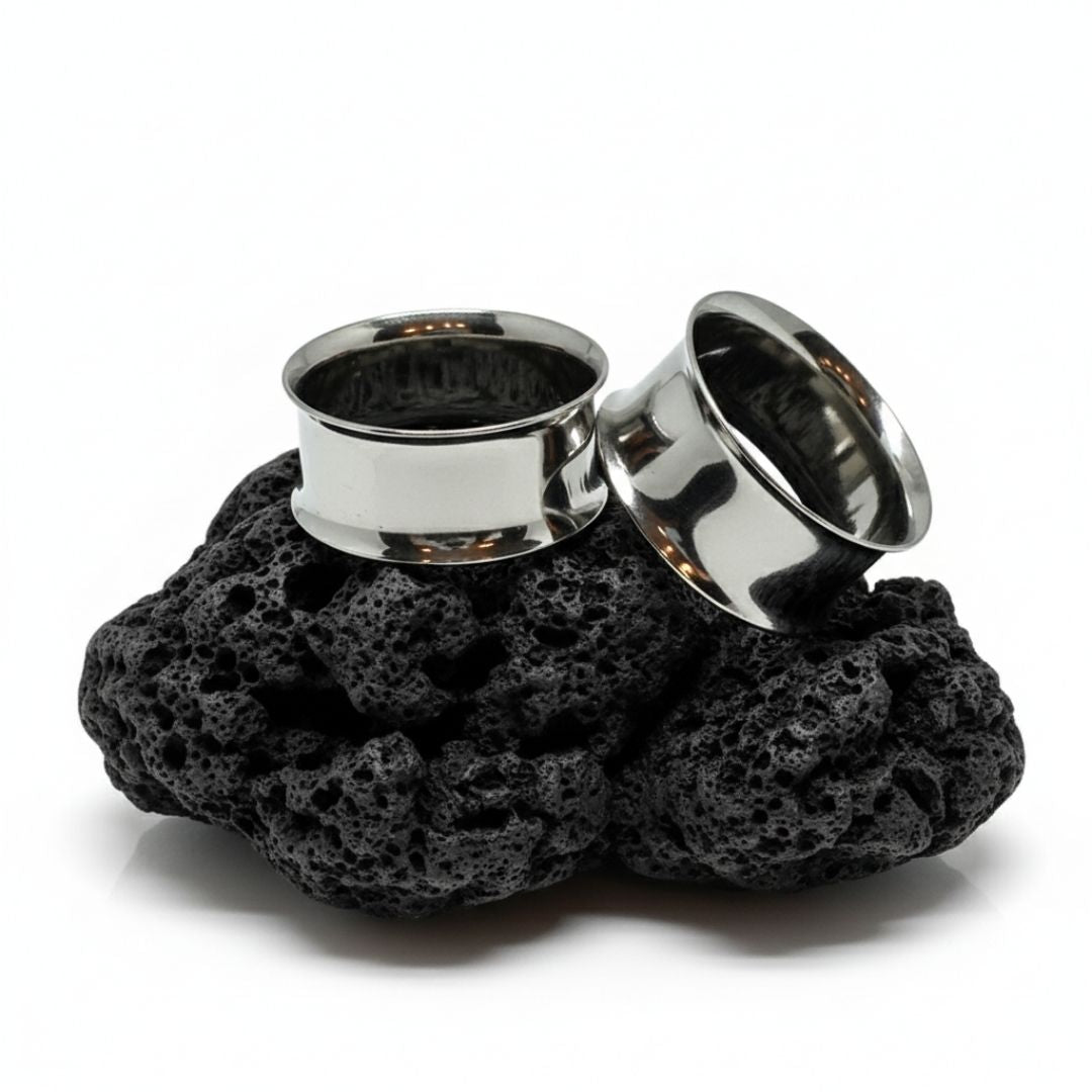 Pair of double flare surgical steel tunnels, showing the hollow center. Best gauges for stretched ear piercing culture.