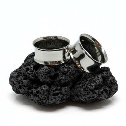 Pair of double flare surgical steel tunnels, showing the hollow center. Best gauges for stretched ear piercing culture.