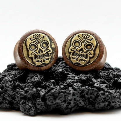 Pair of organic wood plugs carved with intricate Sugar Skull / Dia de Muertos design. Dark brown wood gauges 8mm-16mm.
