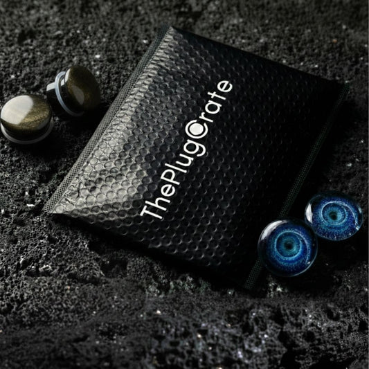 An envelope and two pairs of high quality plugs for stretched ears