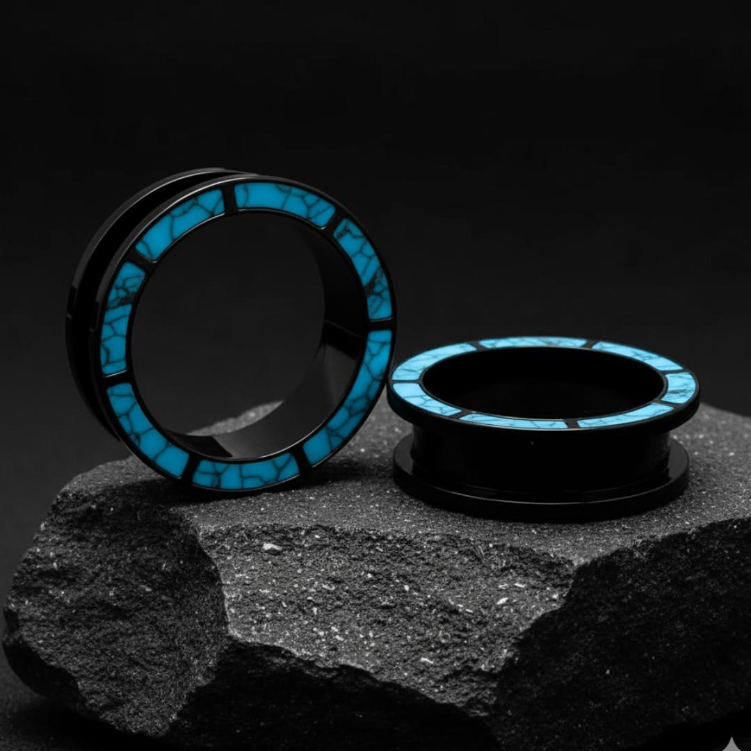 Turquoise steel plugs on a black volcanic stone