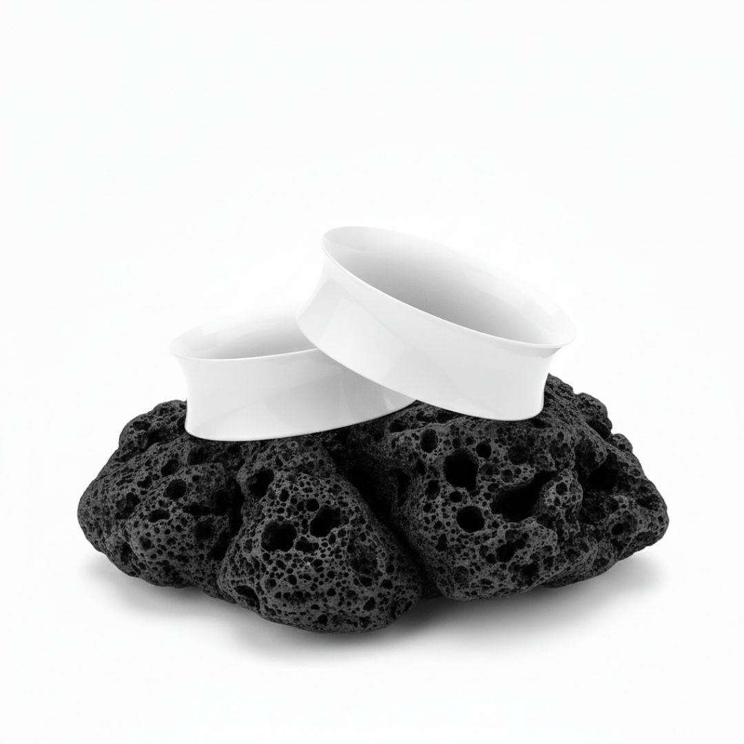 Pair of solid white silicone tunnels (plugs/gauges) for stretched ears. Flexible, lightweight alternative body jewelry.